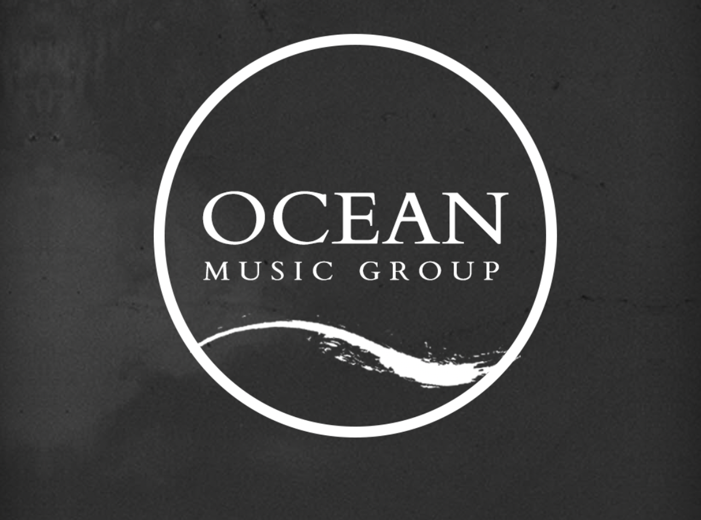 The Ocean Music Group logo: a white circular badge with the label name and a brush-stroke wave, on a dark textured backdrop.